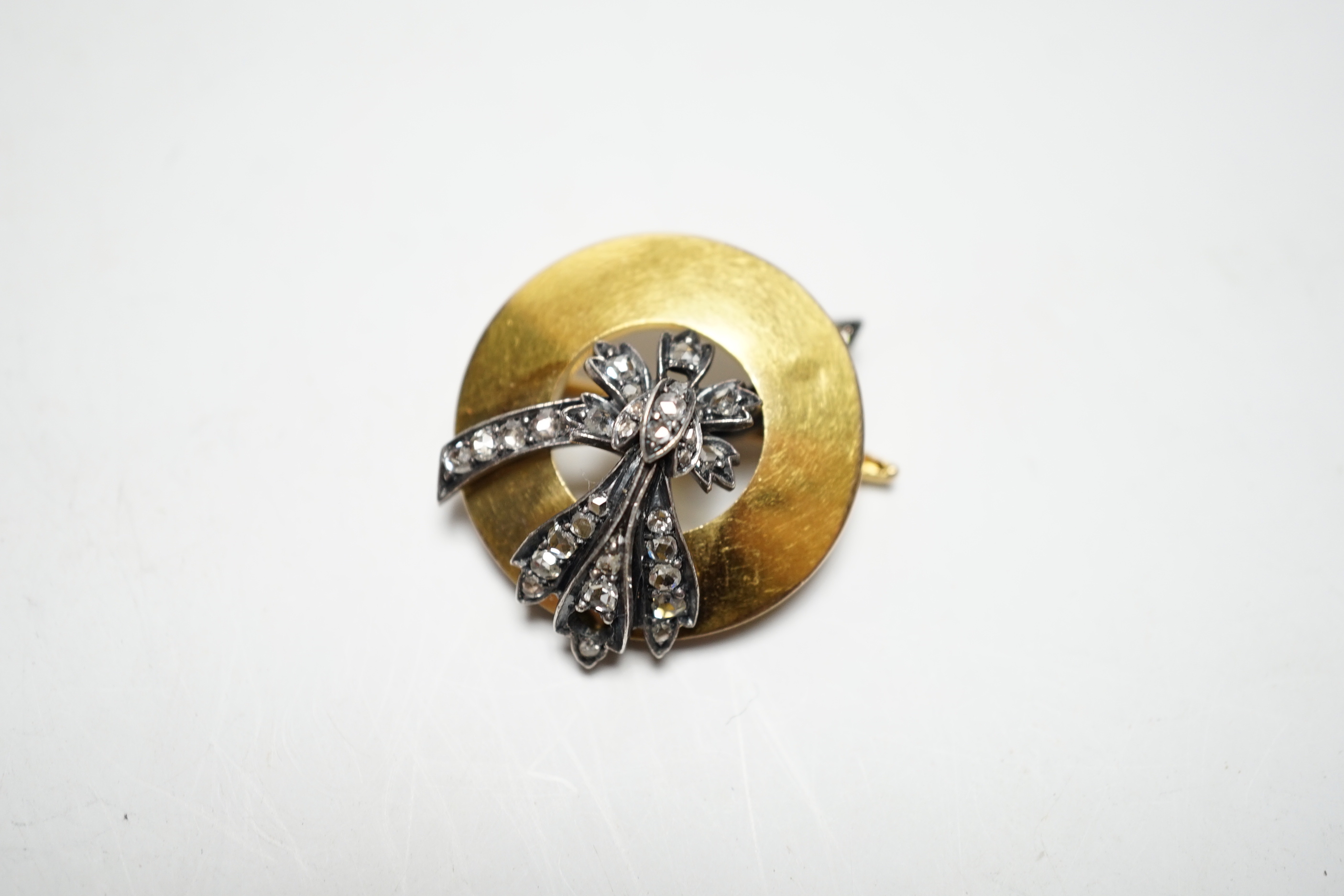 An early 20th century yellow metal and rose cut diamond cluster set circular brooch, 31mm, gross weight 10 grams.